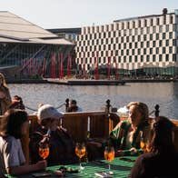 A group of people enjoying drinks in the outside seating area of Charlotte Quay Restaurant