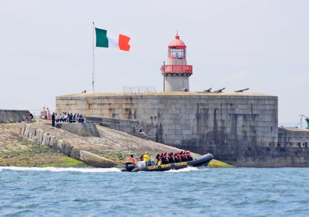 Goat Boat Tours group on a boat passing the East Pier Lighthouse in Dun Laoghaire