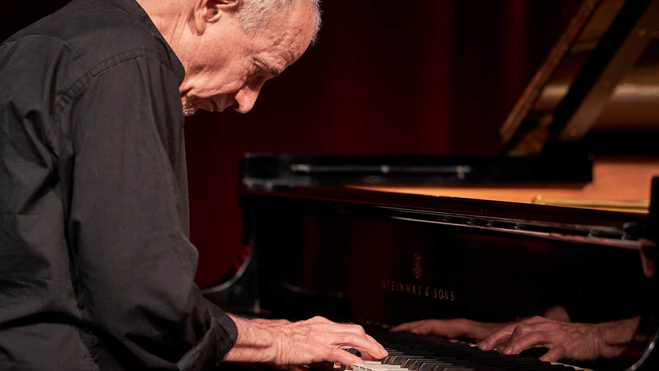 Marc Copland playing a piano.
