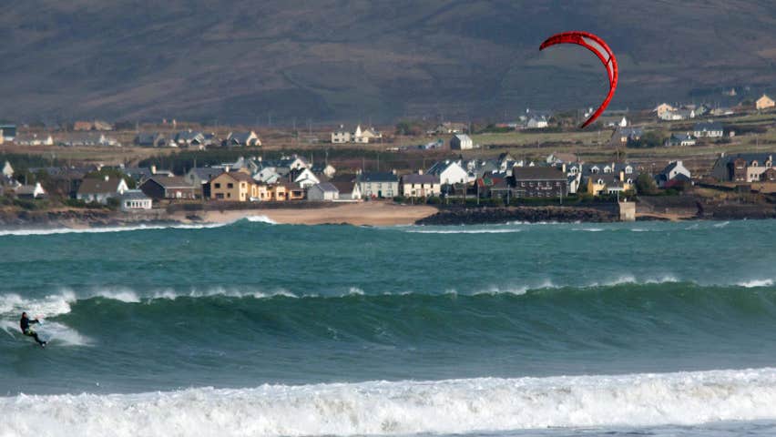A man kitesurfing on a sea swell