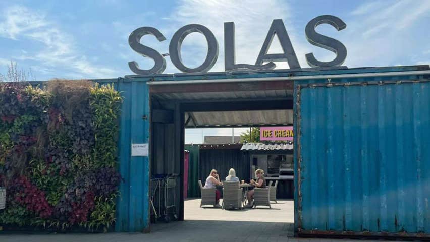 Entrance area of Garden Centre which goes through a doorway cut out of a blue shipping container