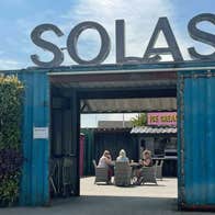 Entrance area of Garden Centre which goes through a doorway cut out of a blue shipping container