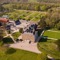Aerial view of a large Georgian house on a large estate