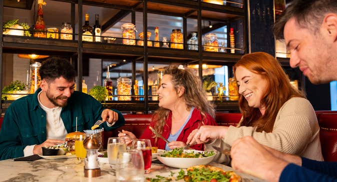 Four people enjoying a meal.