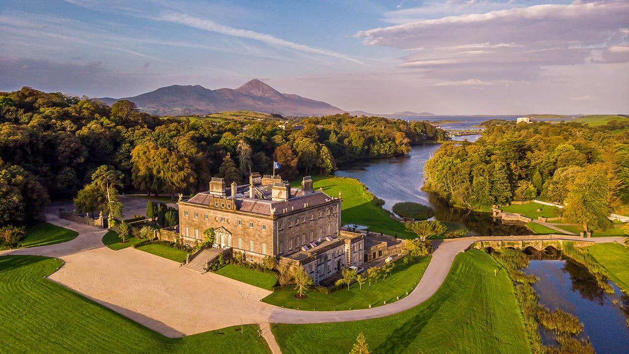 An aerial view of a large period house with an extensive garden