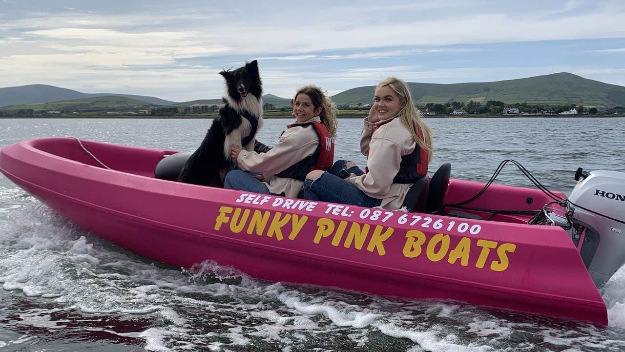 Two people in a boat with a dog