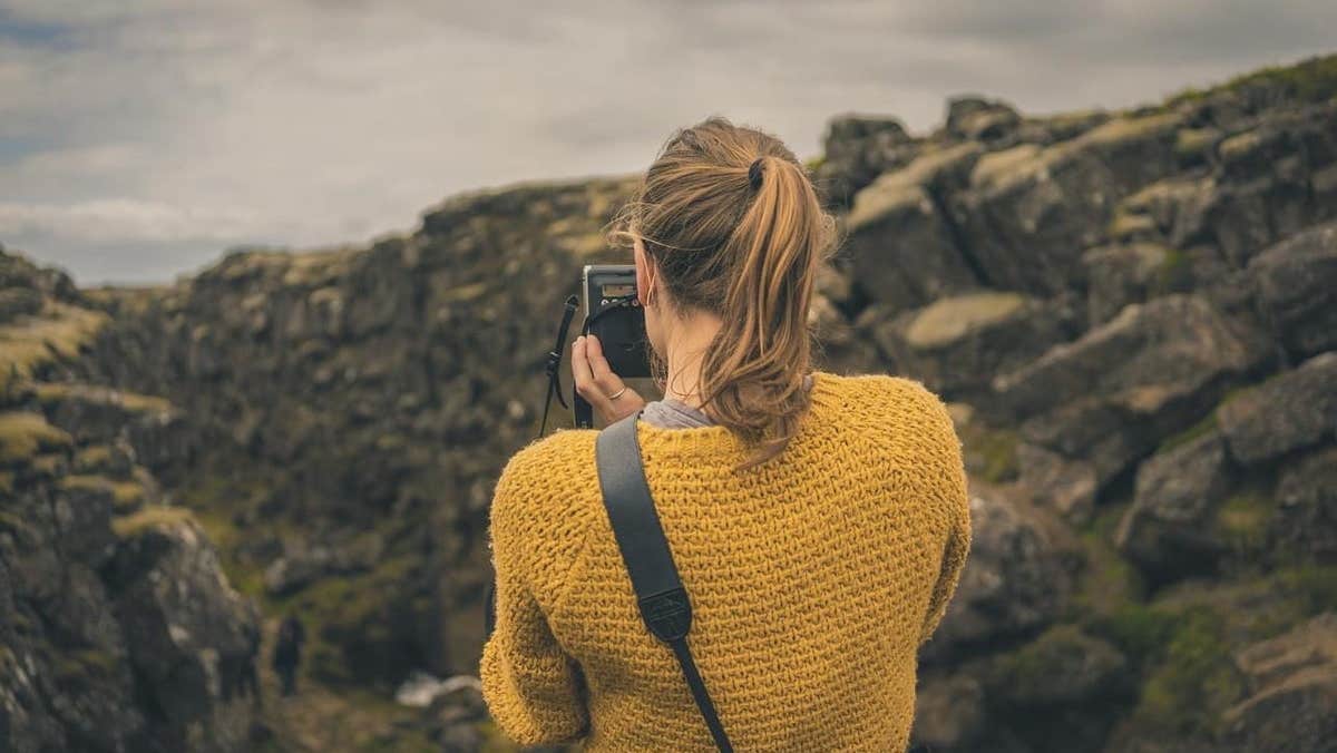 A lady taking a photograph while on a tour with Killarney Photo Tours