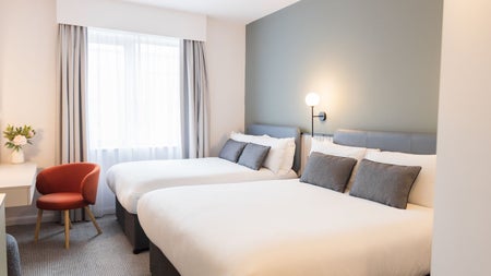 Twin bedroom with white sheets