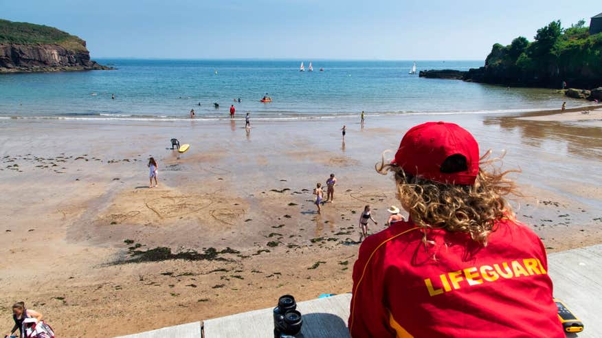 A lifeguard watching people swim at Dunmore East, Waterford