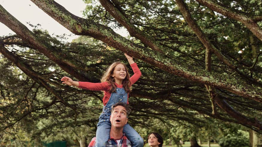 Two children and their father tour the Malahide Gardens.
