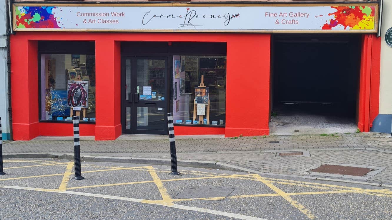 A colourful shop front on a street in a town