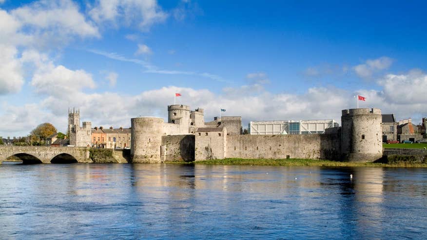 Blue sky and river view with a backdrop of King John's Castle, Limerick