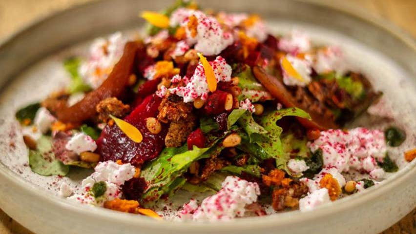 A plate with a mix of rice and peppers and greens from House of Plates Restaurant