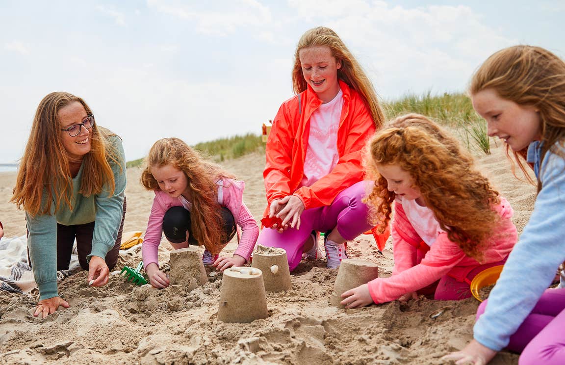 A mother and her four daughters making sand castles on Curracloe Beach in County Wexford.