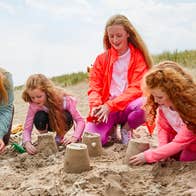 A mother and her four daughters making sand castles on Curracloe Beach in County Wexford.