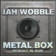 Image of metal grey square box with black speaker in the middle.