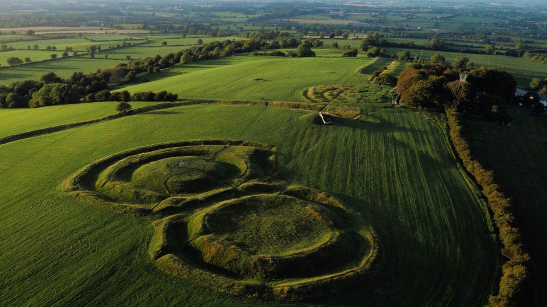 The remains on the Hill of Tara in a green field.