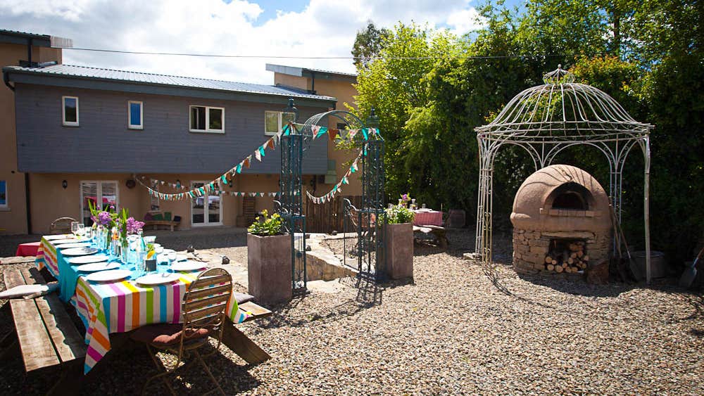 A courtyard set up with a table for outdoors eating.