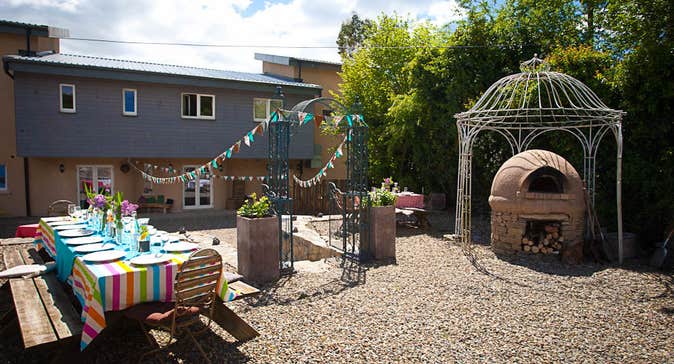 A courtyard set up with a table for outdoors eating.