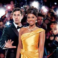 A smiling woman in bright yellow evening gown beside man in tuxedo holding out an open hand in a warning manner