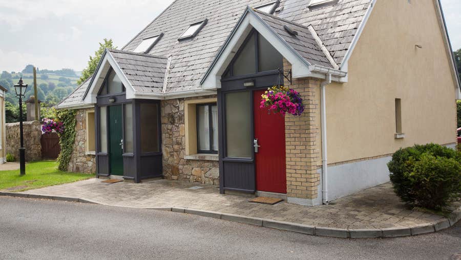 Exterior of lodges with hanging flower baskets