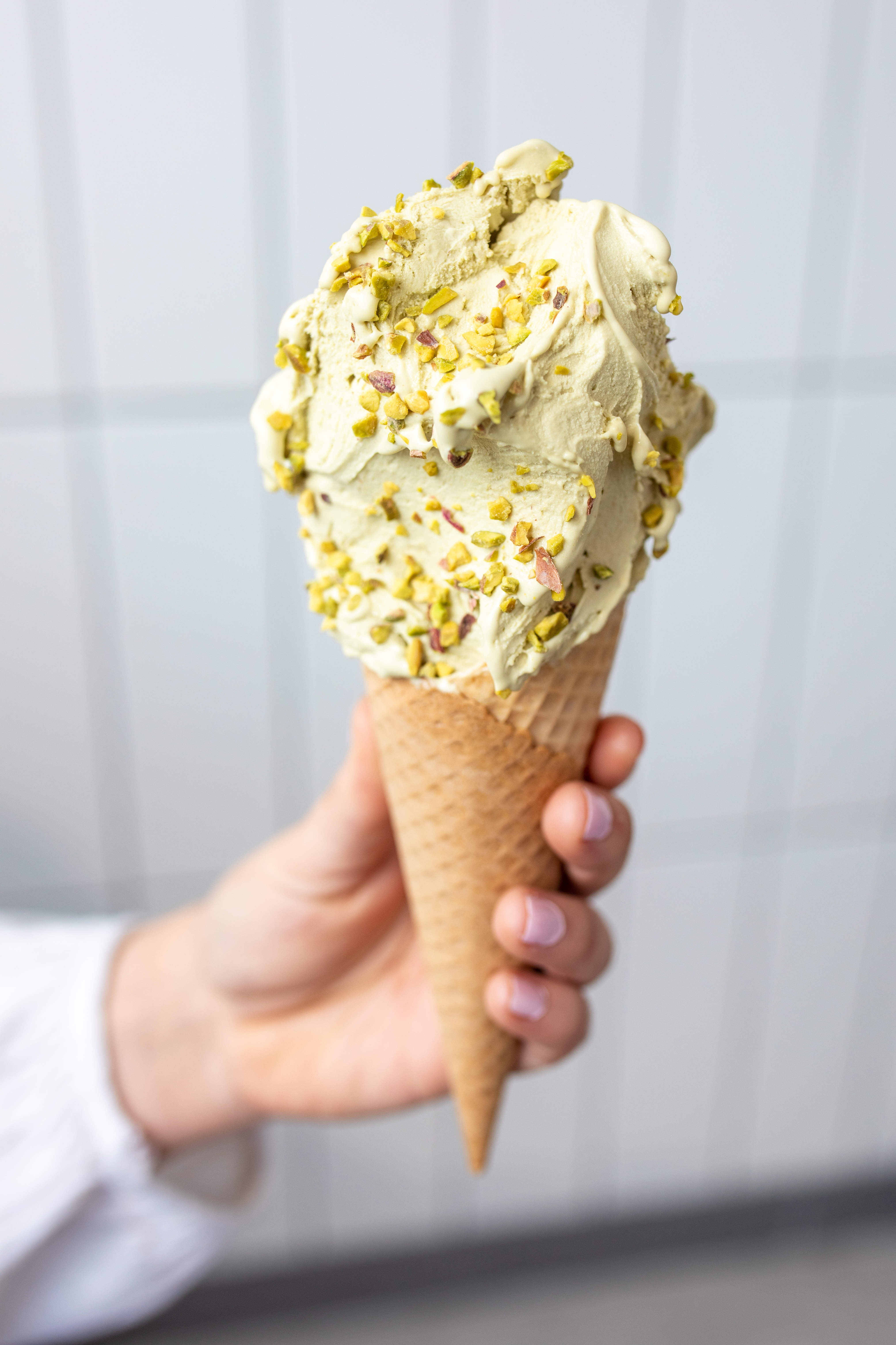A Ginos Gelato cone with sprinkles on top