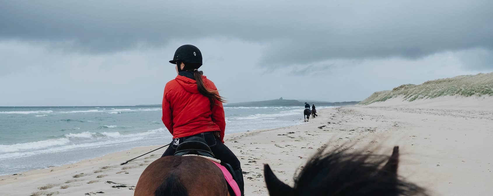 Girl horseriding on the beach