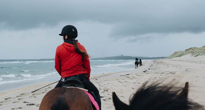 Girl horseriding on the beach