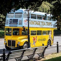A yellow and blue vintage double decker bus