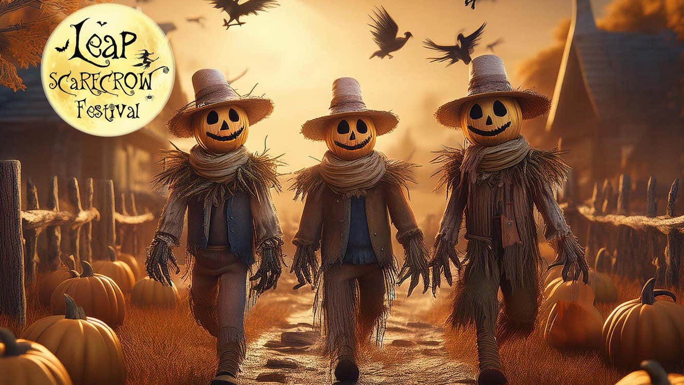 Brown and orange image of 3 people with pumpkin heads walking along a road with pumpkins either side in a village.