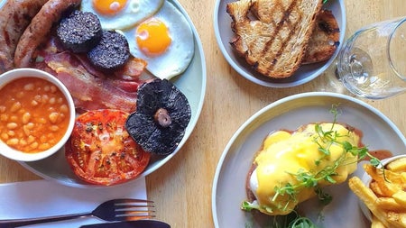 Full cooked breakfast dishes with toast