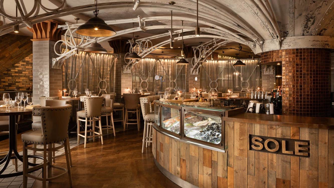 Interior of a restaurant with a business name on the bar