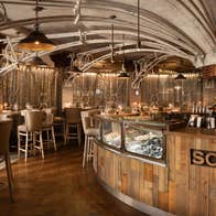 Interior of a restaurant with a business name on the bar