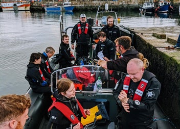 Crew on the dive boat at the pier preparing to go on a dive trip