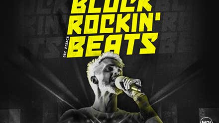 Block Rockin Beats - Dec Pierce, black and white image of man singing into mic he's holding with bright yellow text above.