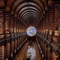 Gaia an illuminated artwork of the Earth by Luke Jerram on display in the Old Library