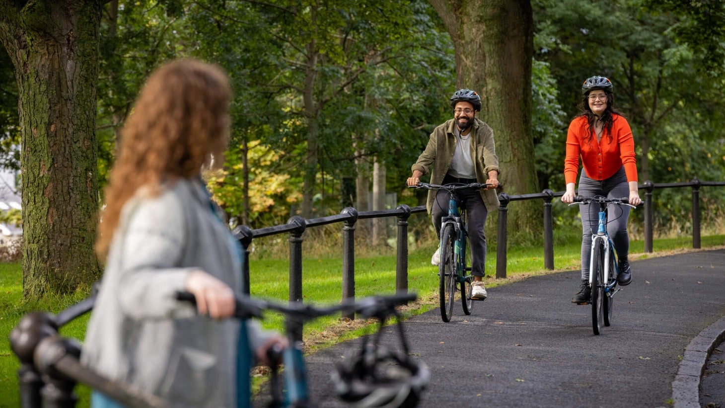 Image of cyclists in a park.