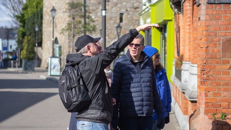 People on a street with a tour guide