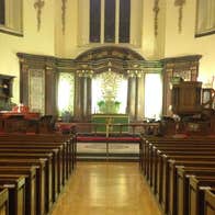An aisle with pews leading up to an altar