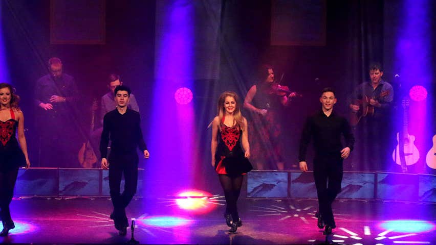 Dancers performing on stage with Trad on the Prom