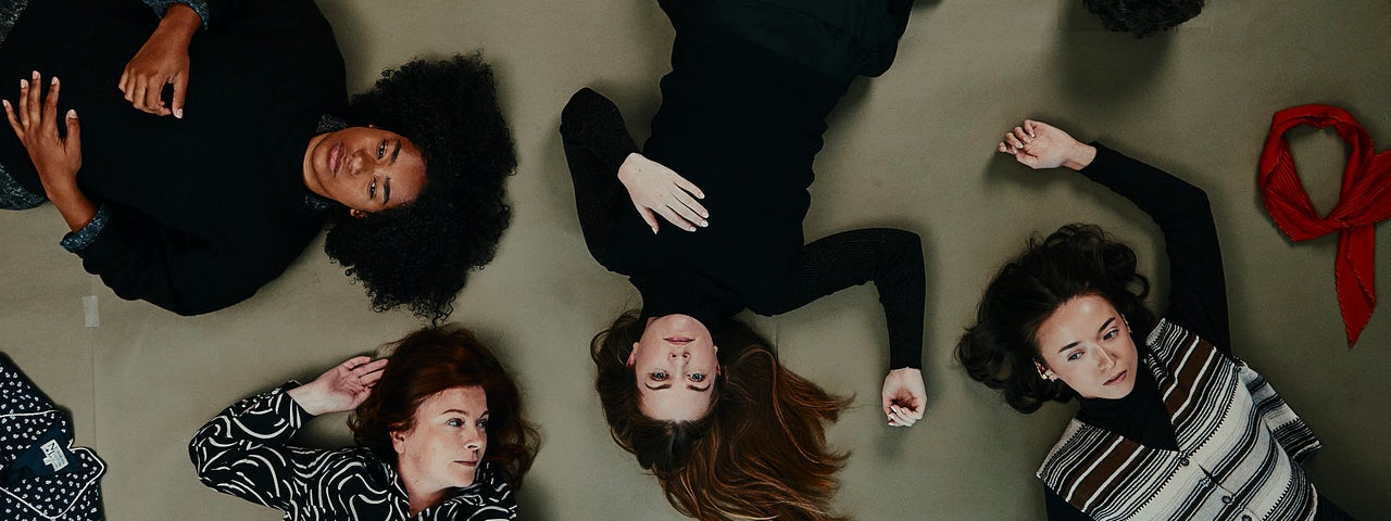 people lying on the floor in a random way, viewed from above looking down at them