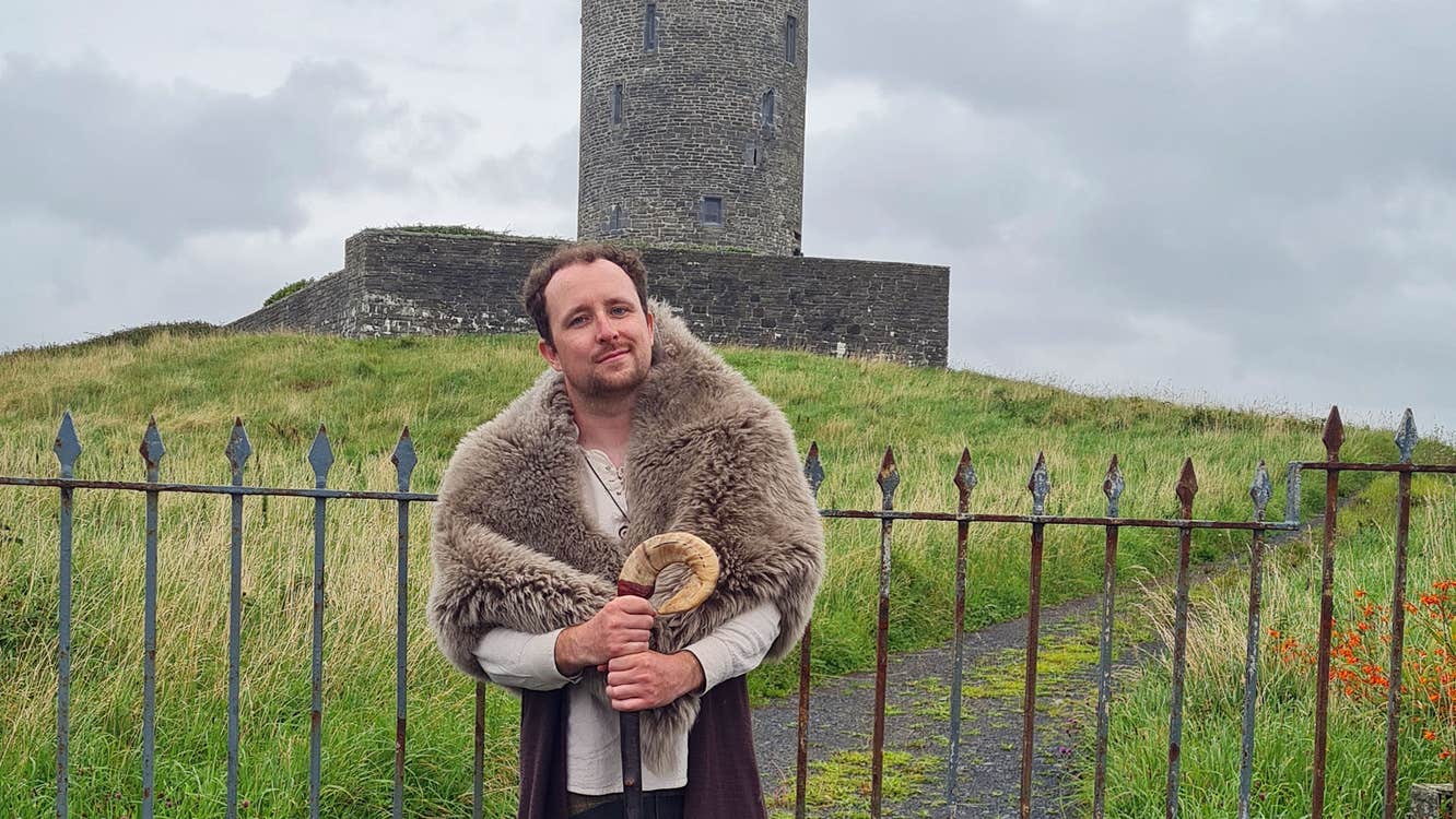 Balor Otherworld guide telling stories in front of an old stone tower