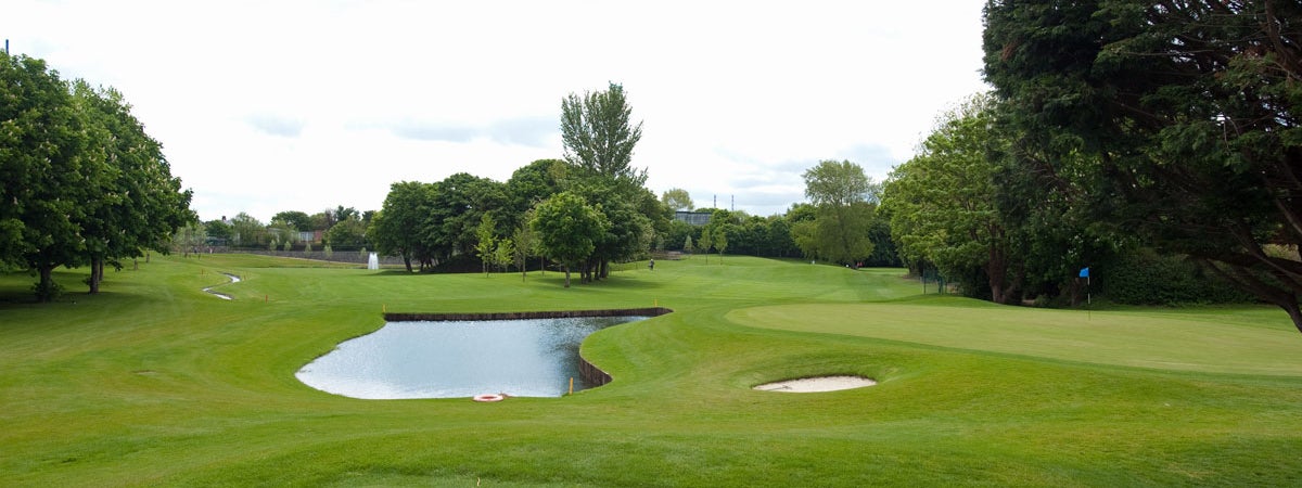 View of 13th and 14th fairways with pond in the centre and small bunker to the right