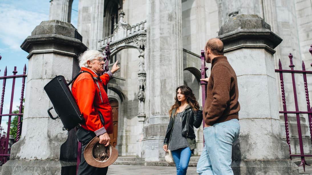A couple listening to a guide on a Cork City Walking Tours