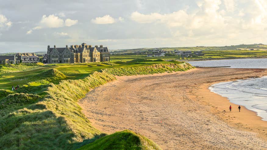 People walking on the beach by Trump International Golf Links and Hotel in Doonbeg, County Clare