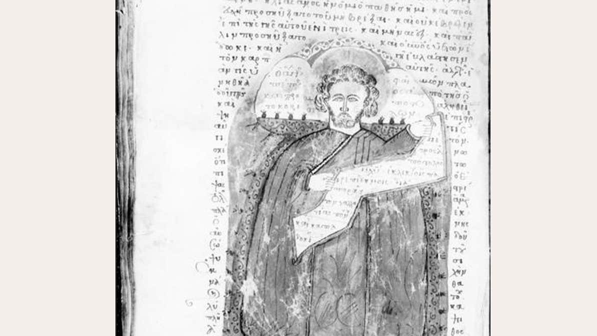Faded picture of old manuscript with fancy text and picture of ancient person