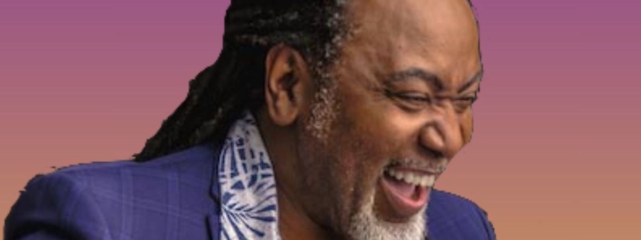A laughing man with eyes shut.