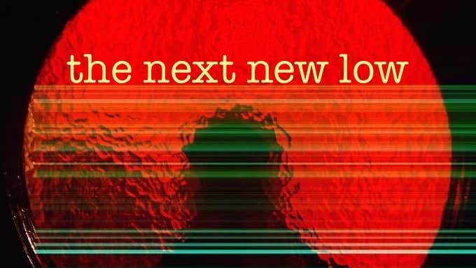 A round circle of red glass with silhouette of person outside against black background.