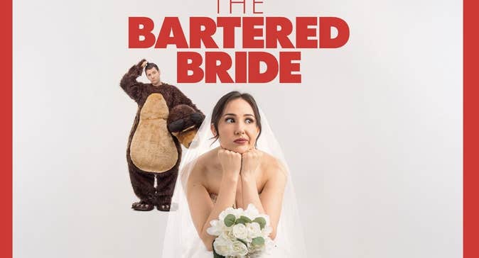 A woman in a bridal gown with bouquet of flowers looking thoughtful with man behind in a brown furry bear costume, scratching his head.