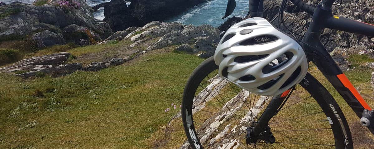 One bicycle sitting beside coastal view